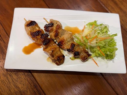 Grilled chicken skewers with salad
