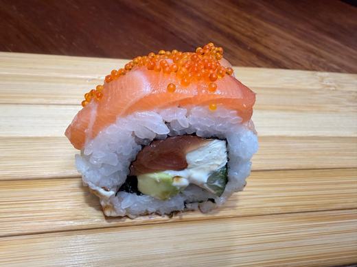 Salmon roll topped with salmon and roe