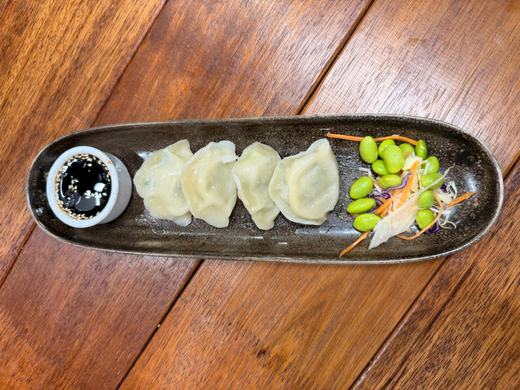 Gyoza dumplings with edamame on a long plate